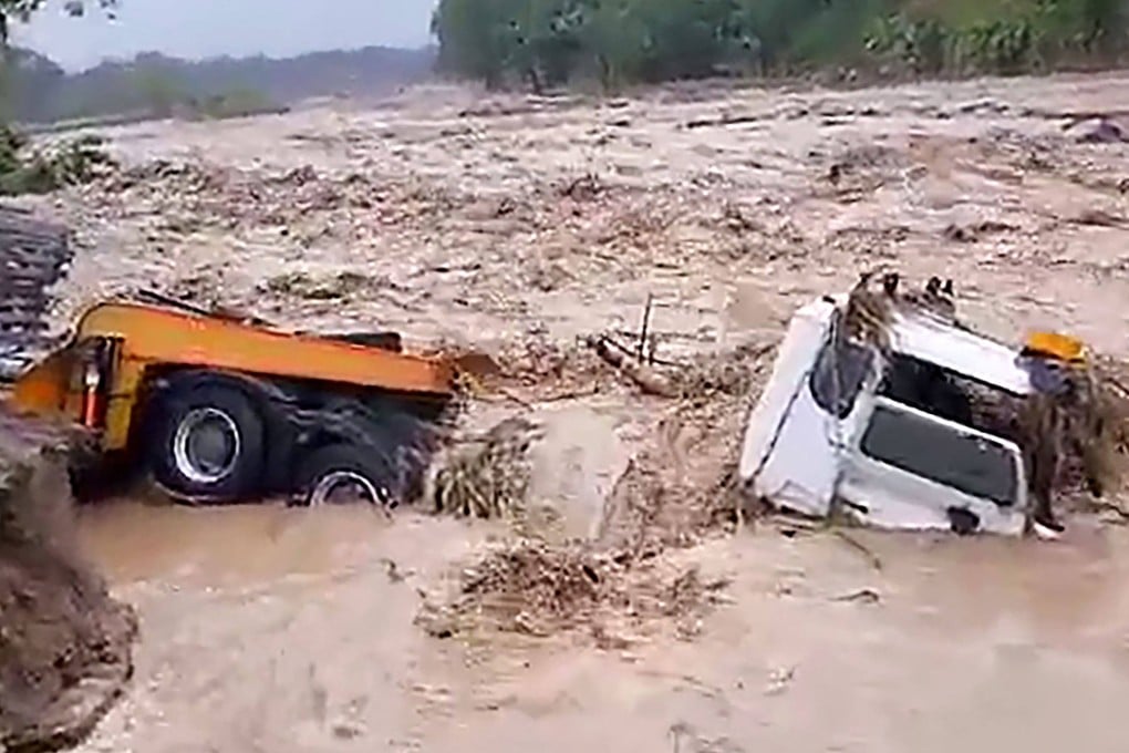 A truck is engulfed by floodwaters brought on by heavy rains from tropical cyclone Maila in the Tinputz district of Northern Bougainville. Photo: AFP
