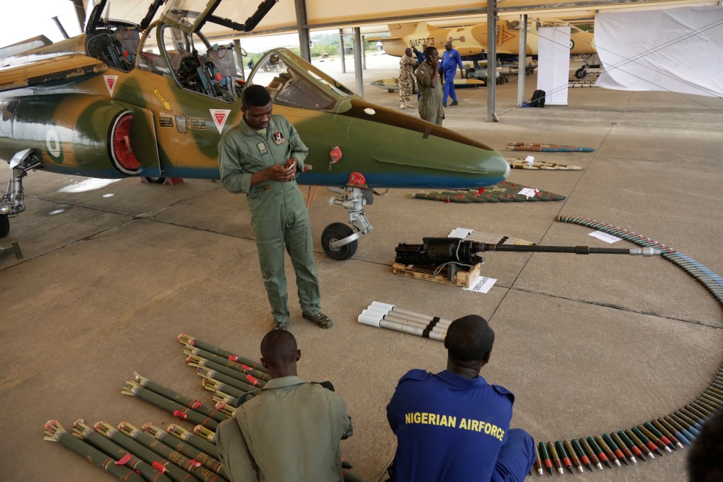Nigerian Air Force officers display ammunition next to a fighter jet in 2017. Photo: AP
