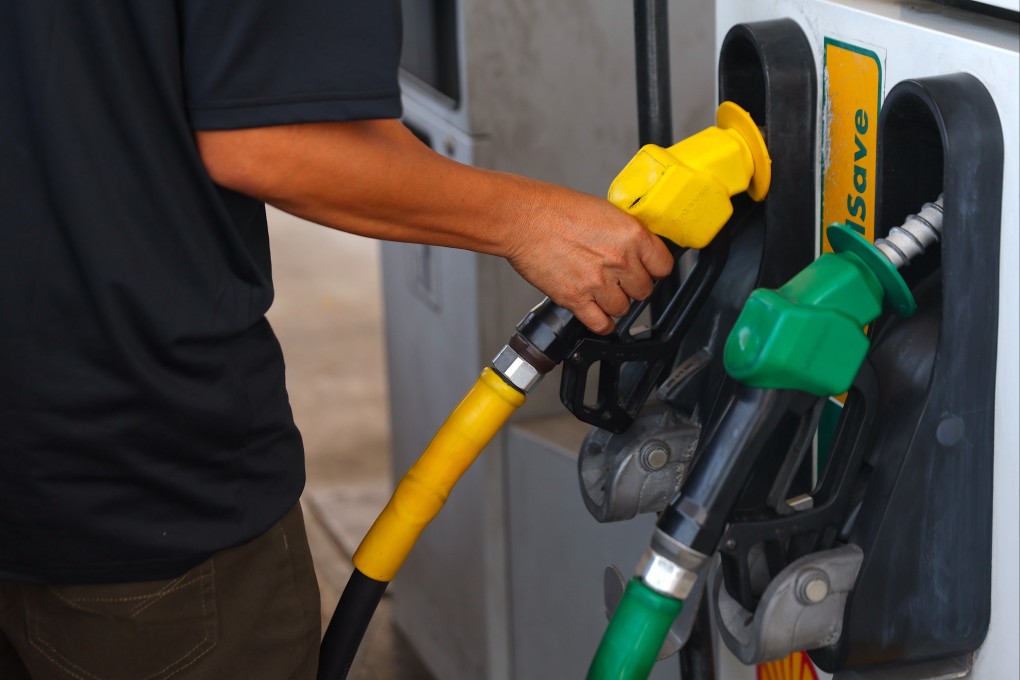 A man holds a nozzle at the petrol station in Negri Sembilan in March. Malaysia is taking tougher action against the possible abuse of a fuel subsidy meant for locals. Photo: EPA