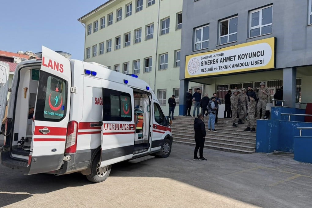 Turkish security forces and emergency staff stand at the courtyard of a high school where an assailant opened fire, in Siverek, south east Turkey on Tuesday. Photo: via AP