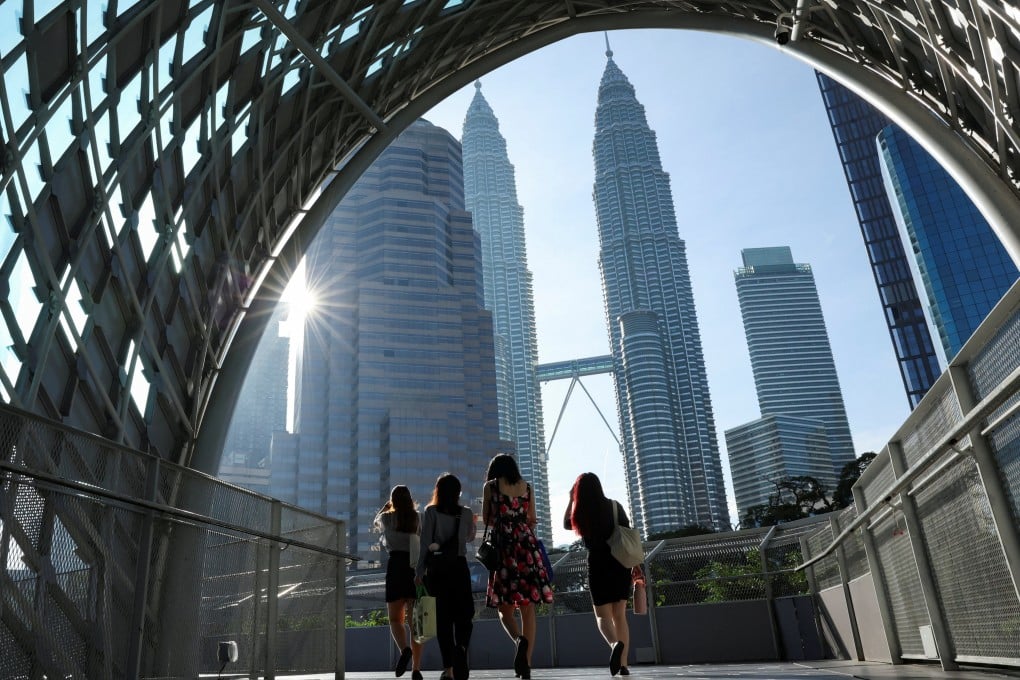 People walk to their workplace during the morning rush at Kuala Lumpur city centre, Malaysia. Photo: Reuters