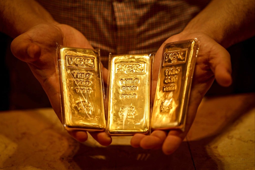 A dealer displays gold bars in a shop in Dubai’s Gold Souk on April 13. Photo: AFP