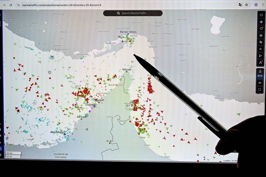 A person points at a website tracking marine traffic and showing commercial vessels on the edge of the Strait of Hormuz near the Iranian coast last month. Photo: TNS