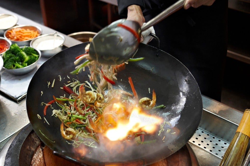 A chef at work at the Four Seasons Hotel Cairo’s 8 Restaurant. The woks used at the Cairo restaurant are sourced from China. Photo: Four Seasons Hotel Cairo at Nile Plaza