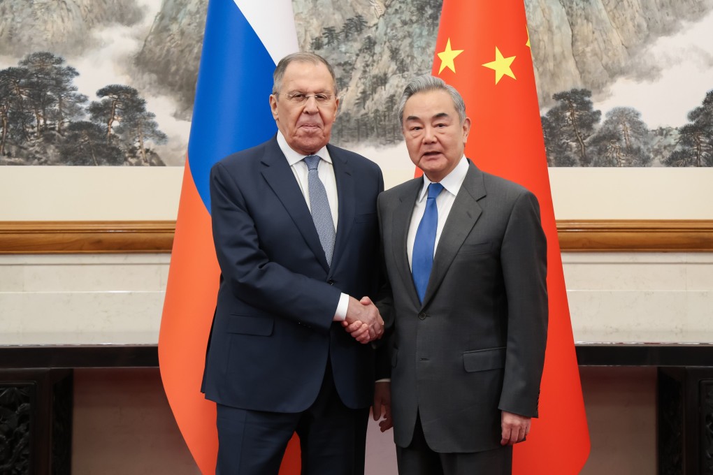 Russian Foreign Minister Sergey Lavrov (left) and Chinese Foreign Minister Wang Yi pose before talks in Beijing on Tuesday. Photo: EPA
