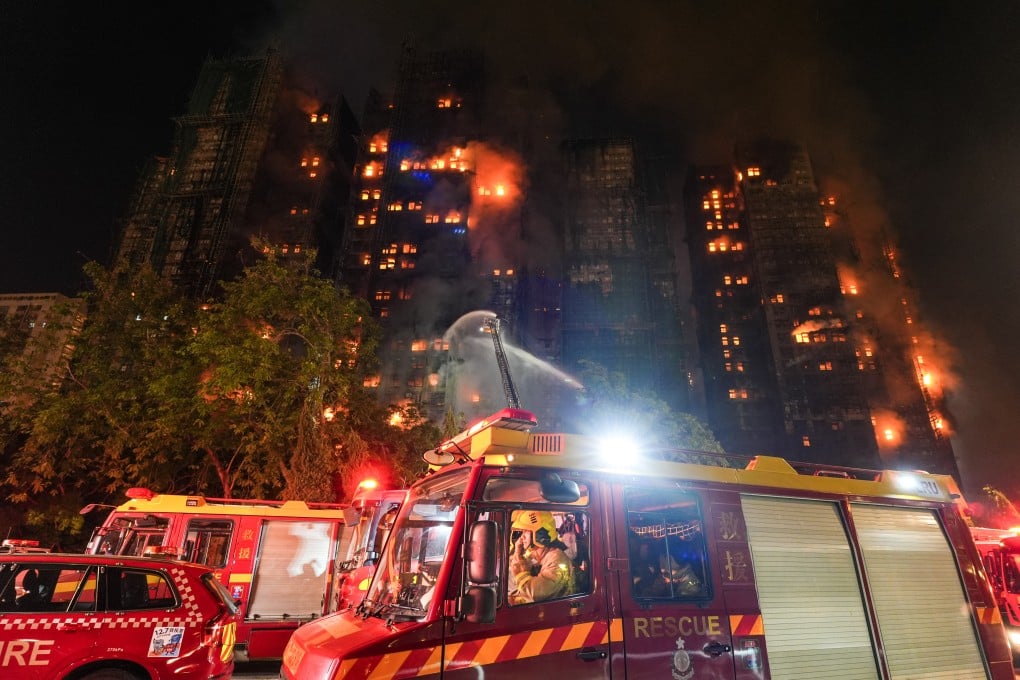Teams of firefighters battling the blaze in Tai Po on the night of November 26. Photo: Eugene Lee