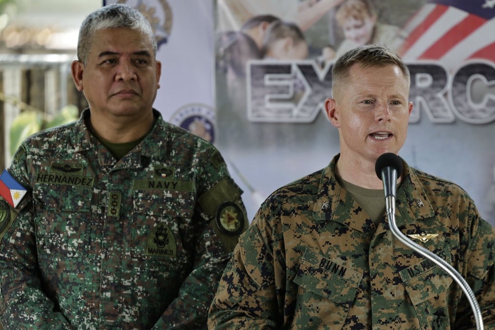 Philippine Navy Colonel Dennis Hernandez (left) looks on as United States Marines Colonel Robert Bunn speaks during a Balikatan briefing on Tuesday. Photo: EPA