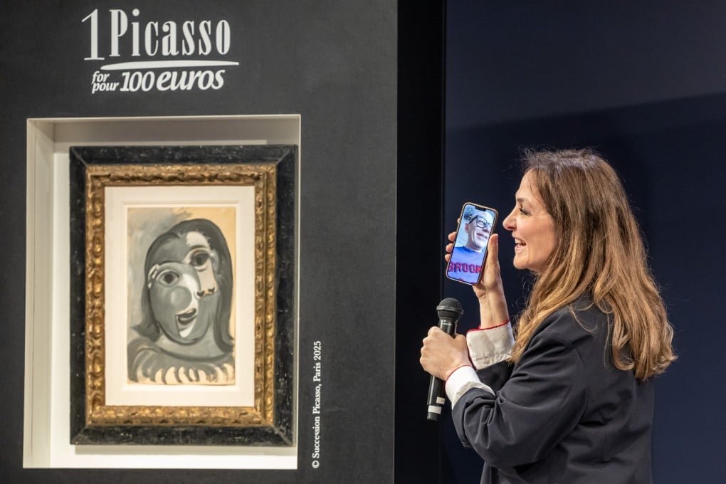 Charity founder Peri Cochin speaks on the phone with the raffle winner in Paris, France, on Tuesday. Photo: EPA