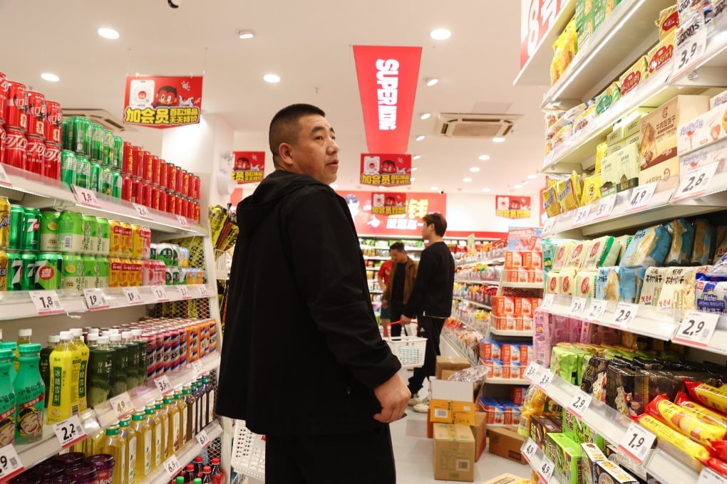 A man shops in a Beijing supermarket on Tuesday. China’s retail sales rose 1.7 per cent year on year in March. Photo: EPA