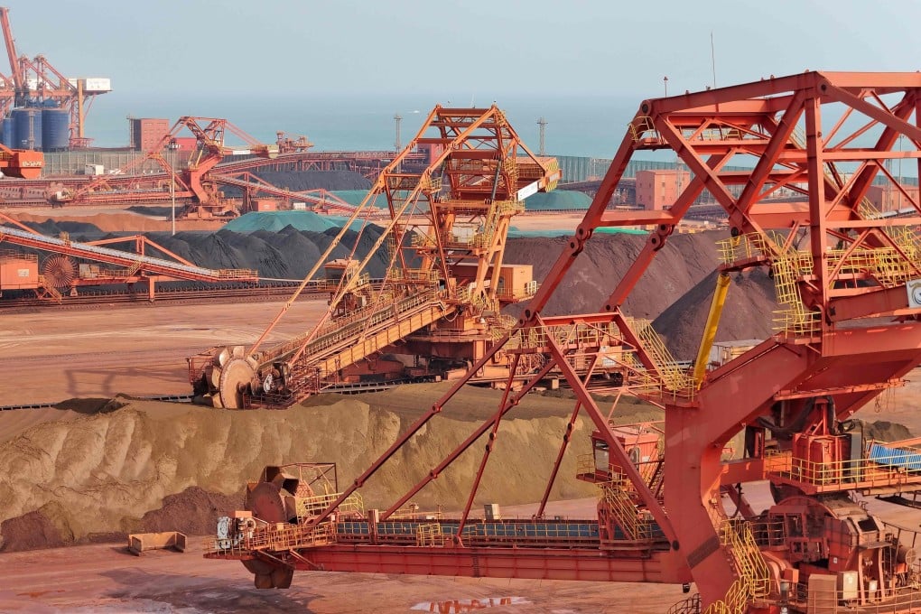 Heavy machinery handling bauxite and iron ore is seen in China’s eastern Shandong province. Photo: AFP