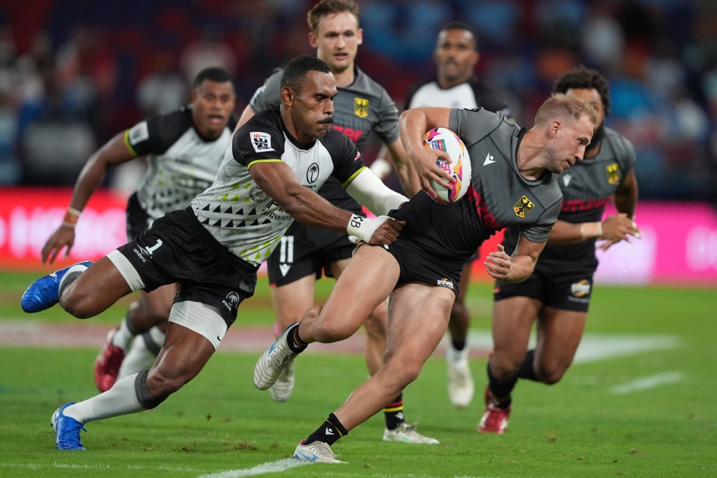 Niklas Koch tries to wriggle clear of Fiji’s Kavekini Tanivanuakula during Germany’s opening Cathay/HSBC Sevens clash. Photo: Elson Li