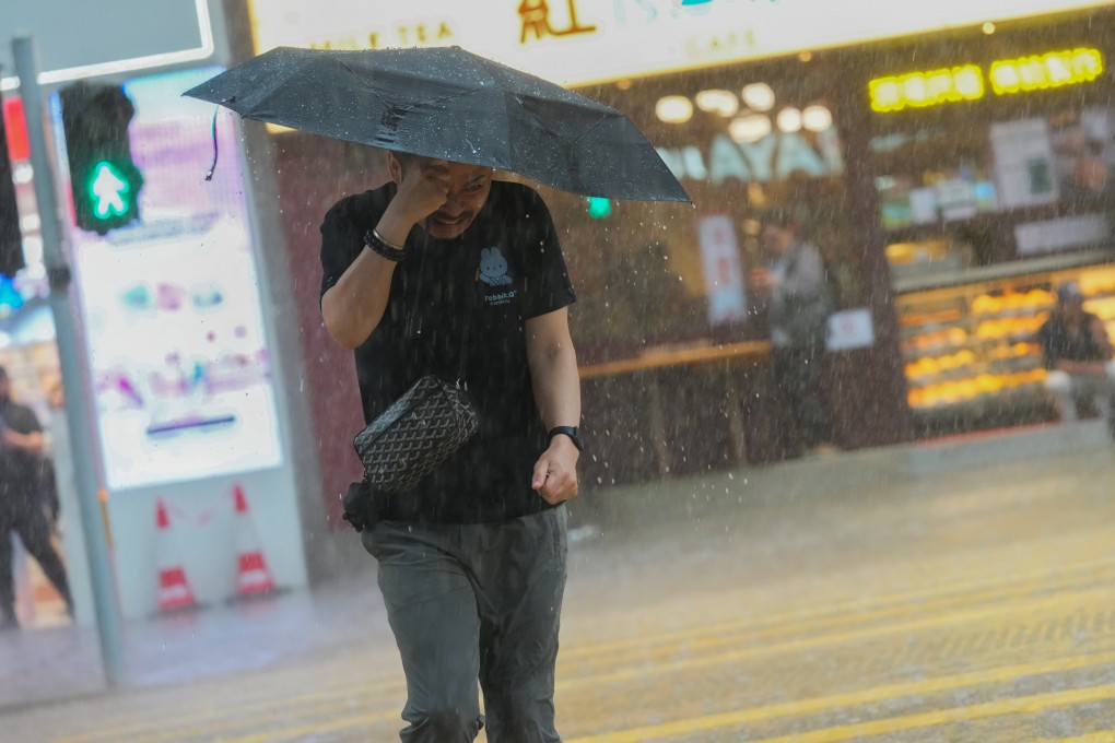 A pedestrian braves the rain in Jordan on Friday. Photo: Jelly Tse