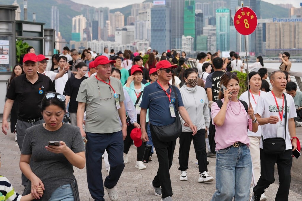 Mainland Chinese visitors and tour groups take photos and stroll along the waterfront in Tsim Sha Tsui on April 14. Photo: Karma Lo