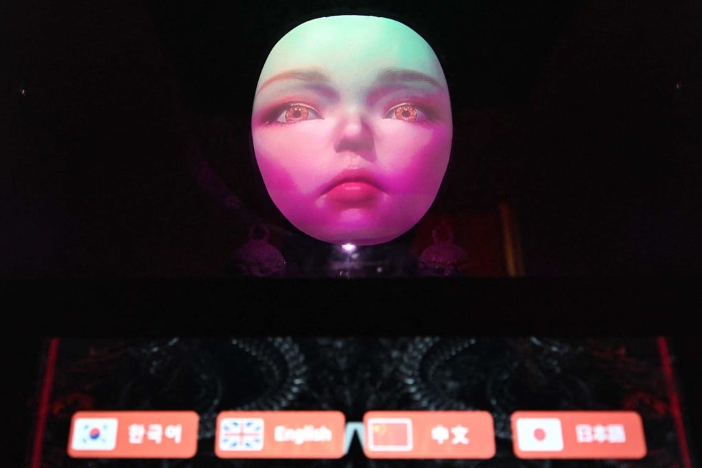 An AI shaman offers to read visitor’s fortunes in four languages at a South Korean shamanism theme shop in Seoul on Wednesday. Photo: AFP