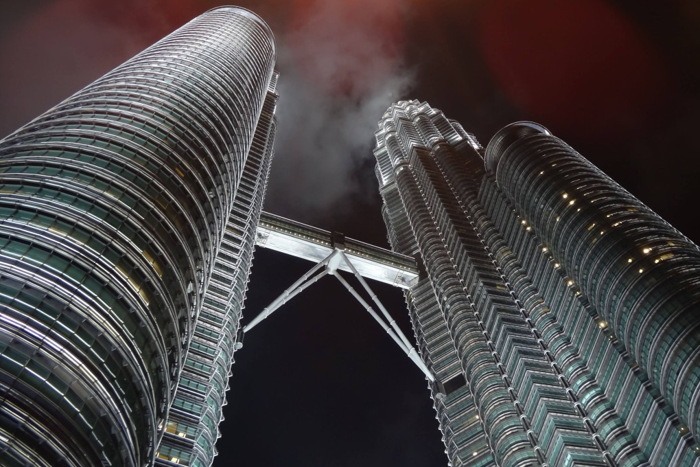 The Petronas Twin Towers in Kuala Lumpur is popular with street photographers, who offer tourists a more professional alternative to a selfie for a fee. Photo: dpa