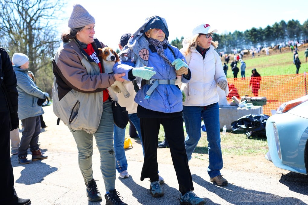 Activists help an elderly woman after she had been tear gassed during an attempt to gain entry into Ridglan Farms beagle breeding and research facility on Saturday, in Blue Mounds, Wisconsin, US. Photo: AP