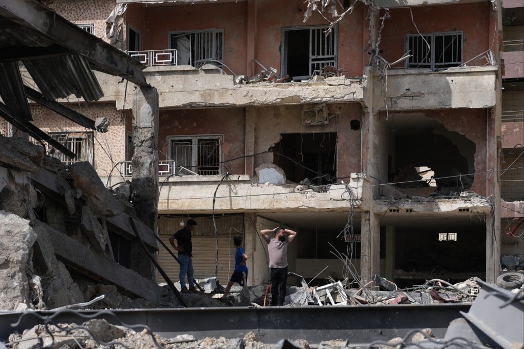 Residents inspect damage at buildings destroyed in Israeli strikes, in Jibchit, southern Lebanon. Photo: AP