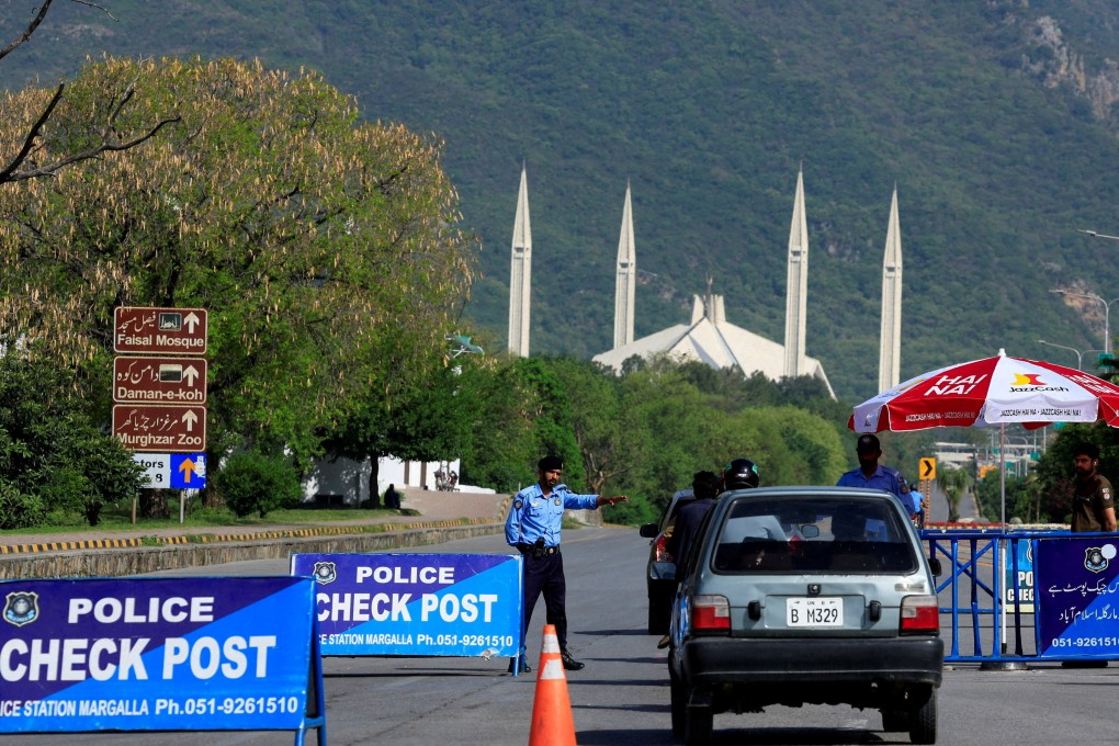 A police officer gestures to a vehicle at a check post near Faisal Masjid on Sunday, as Pakistan tries to convene a tentative second phase of peace talks between the US and Iran in Islamabad. Photo: Reuters