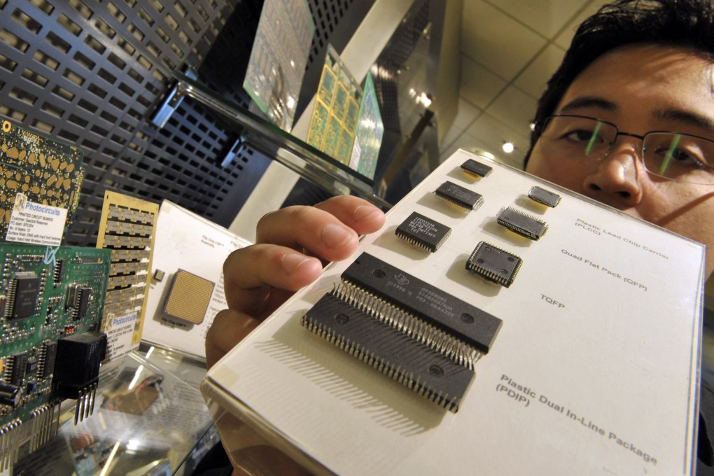 An employee of a semiconductor company in Manila displays computer chips manufactured in the Philippines in 2008. The country has long been confined to the lower-value work of chip assembly, testing and packaging. Photo: AFP
