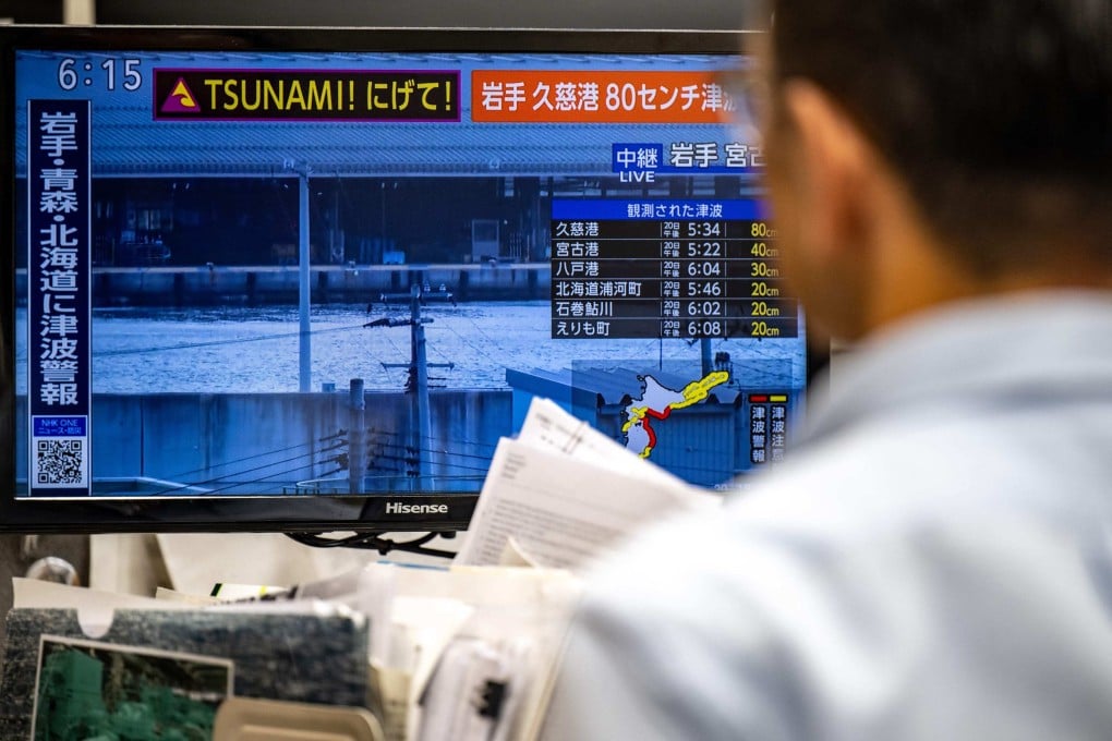 A warning message flashes up on a screen after an earthquake hit northern Japan. Photo: AFP