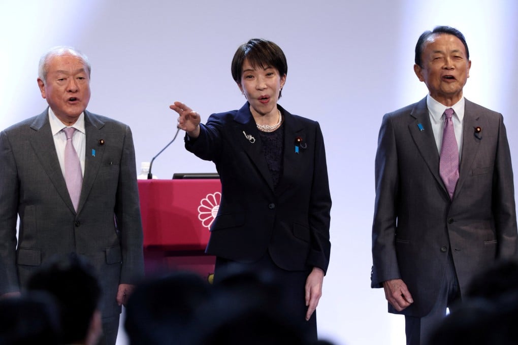 Japan’s Prime Minister Sanae Takaichi, who is also the ruling Liberal Democratic Party leader, sings the party anthem with the party’s deputy president and former prime minister Taro Aso (right) and the party secretary general Shunichi Suzuki (left) on April 12. Photo: Reuters