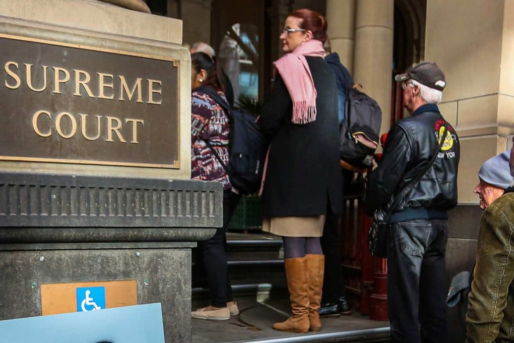 People queue to enter the Supreme Court of Victoria in Melbourne. Photo: AFP