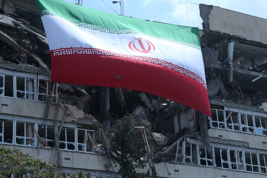 A national flag of Iran hangs from a building in Tehran that was damaged by US-Israeli attacks. Photo: Xinhua