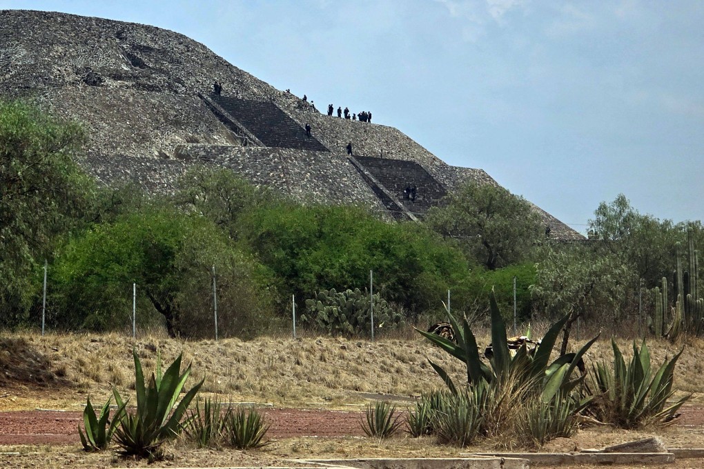 Police officers work on the Pyramid of the Moon at the Teotihuacan archaeological zone following a shooting in Teotihuacan, Mexico on Monday. Photo: AFP