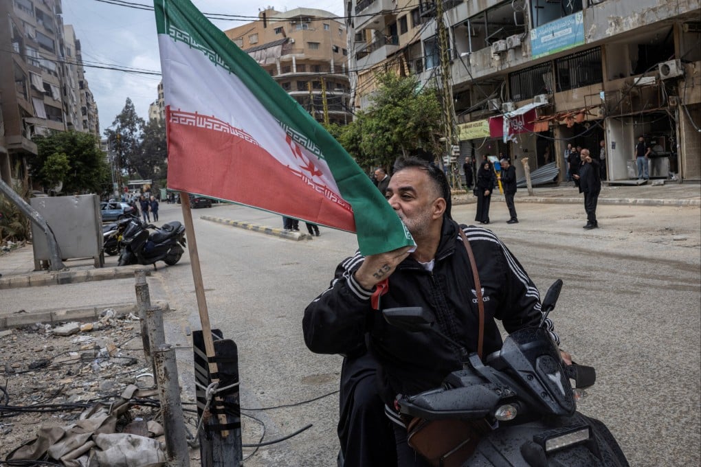 A man kisses an Iranian flag in the southern suburbs of Beirut, Lebanon. Photo: Reuters