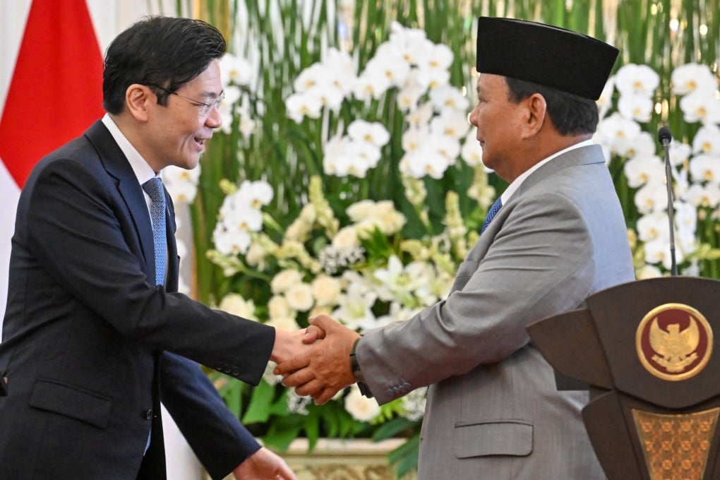 Indonesia’s President Prabowo Subianto (right) shakes hands with Singapore’s Prime Minister Lawrence Wong after a press conference at the presidential palace in Jakarta in November 2024. Photo: AFP
