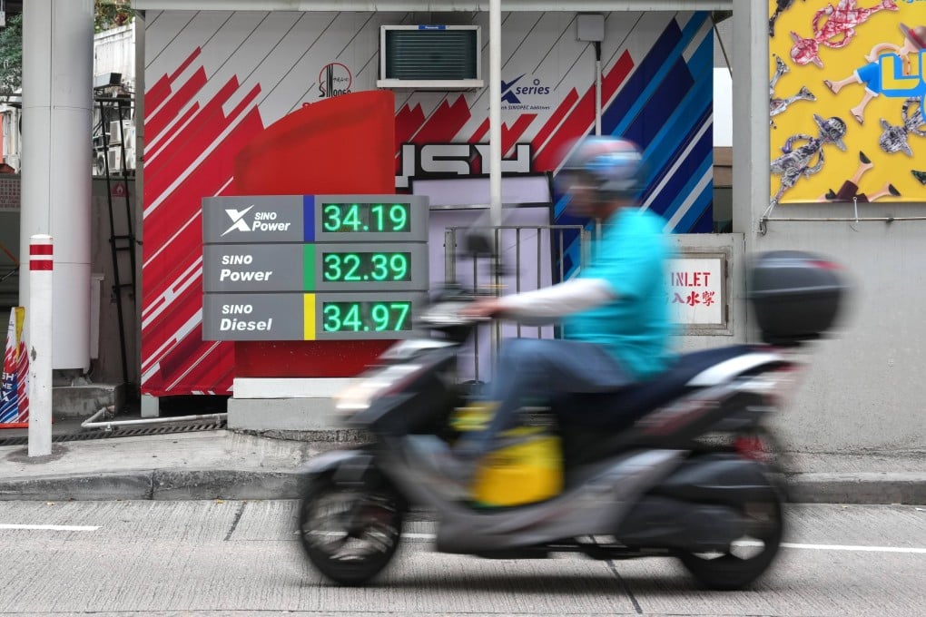 A motorcyclist rides by a price board at a petrol station in Causeway Bay on April 10. Photo: Jelly Tse