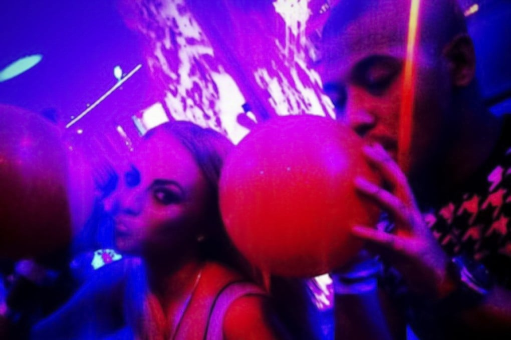 Partygoers in Spain inhale laughing gas (nitrous oxide). The substance was implicated in over 450 serious road accidents in France last year, a number that has multiplied by 40 in six years. Photo: Red Door News