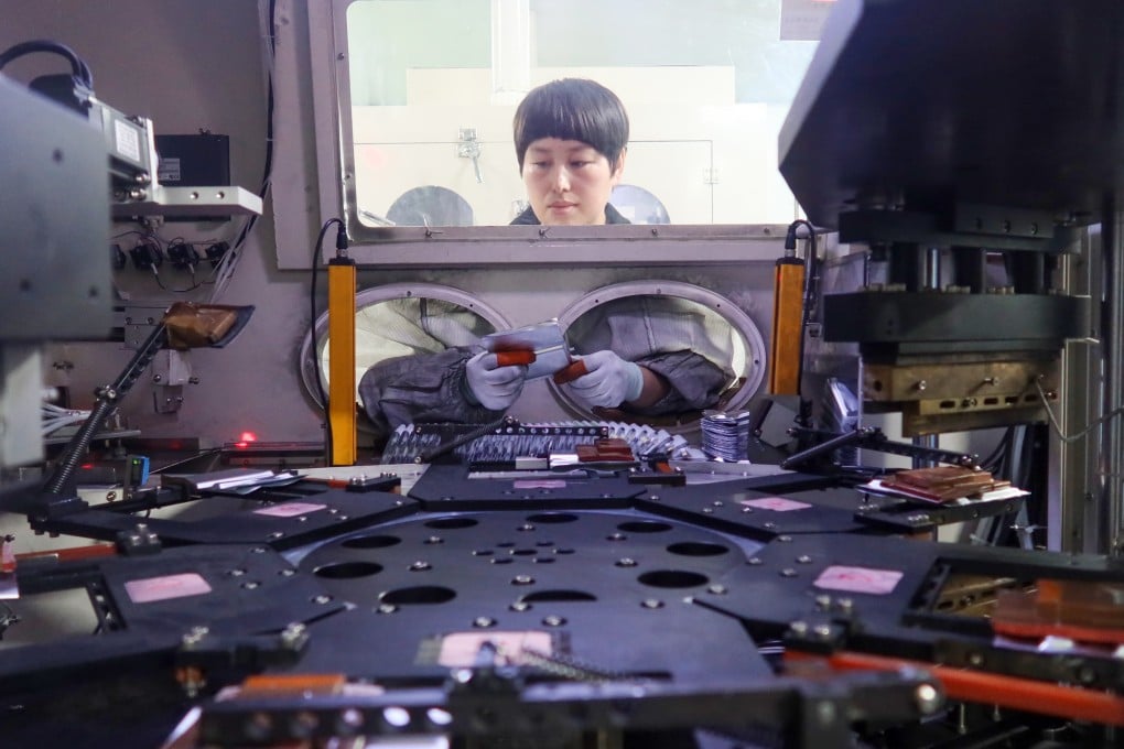 A worker at Henan Pude New Energy Technology assembling lithium-ion batteries in Sanmenxia city, Henan province, China, on March 12. Photo: Getty Images