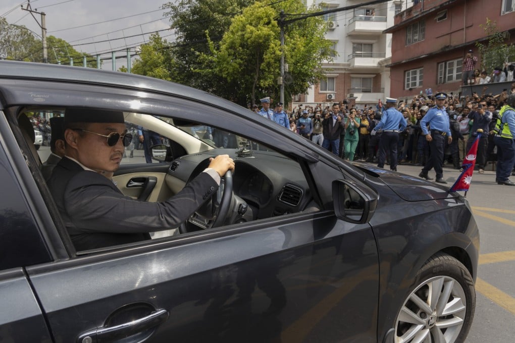 Sudan Gurung, a Gen Z movement protest leader who became Home Minister, drives a car after the oath-taking ceremony outside the presidential office in Kathmandu, Nepal on March 27, 2026. Photo: EPA