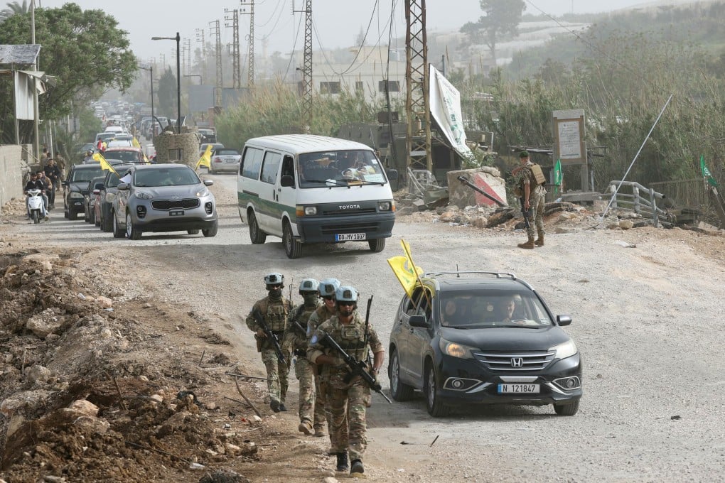 A French contingent of the United Nations Interim Force in Lebanon patrols the area as displaced residents waving Hezbollah flags make their way back to their homes on a makeshift road, in the southern Lebanese area of Al-Qasmiyeh on Saturday. Photo: TNS