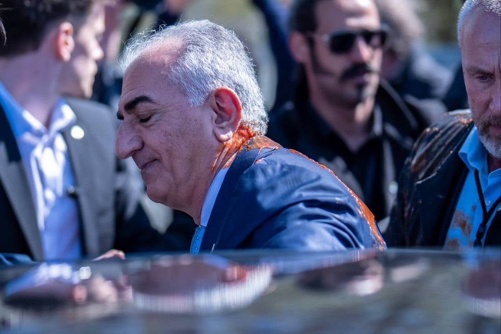 Reza Pahlavi after he was splattered with that appears to be tomato juice or sauce. Photo: dpa