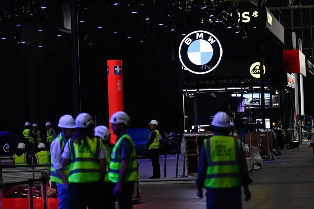 Workers assemble German carmaker BMW’s stand at the China International Exhibition Centre on Wednesday. Photo: AFP