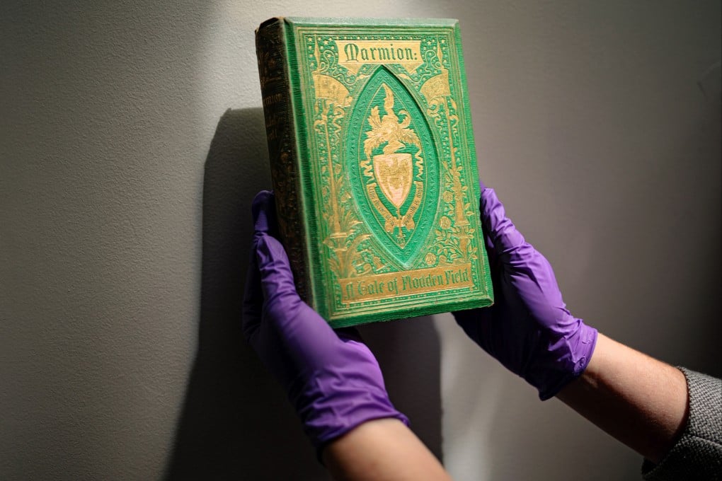 Melissa Tedone, assistant professor of library and archives conservation at the University of Delaware, in the United States, holds a copy of Marmion, a Victorian-era book with a vibrant green, arsenic-based binding. Photo: Getty Images