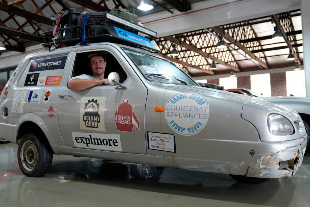 Ollie Jenks poses with “Sheila the three-wheeler”, the Reliant Robin he and his friend Seth Scott drove from London to Cape Town in a successful bid to break the Guinness World Record for the longest trip in a three-wheeled vehicle. Photo: AP
