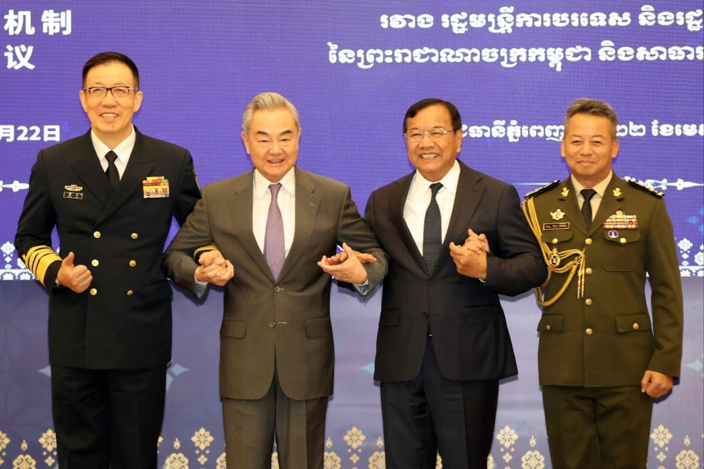 Chinese Defence Minister Dong Jun (from left) and Foreign Minister Wang Yi link arms with Prak Sokhonn, Cambodian deputy prime minister, and Cambodian Defence Minister General Tea Seiha. Photo: Handout/Agence Kampuchea Press