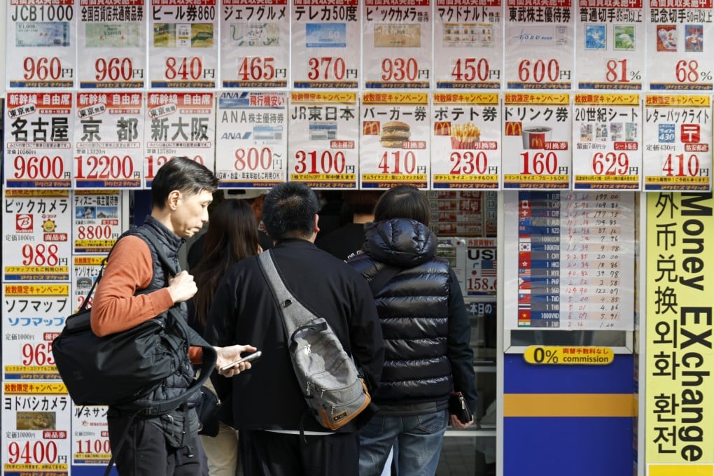Customers queue at a discount ticket shop at Akihabara Electric Town in Tokyo on March 24. The weak yen is fuelling inflation by increasing the cost of imported goods, sapping consumers’ purchasing power and making it harder to tackle Japan’s cost-of-living crisis. Photo: EPA