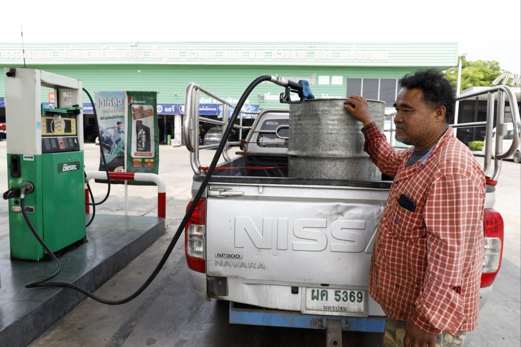 A Thai farmer fills an oil drum with diesel to harvest rice, at a petrol station in Ayutthaya on April 1. Thai farmers are struggling with shortages of diesel, fertiliser and insecticides, alongside rising production costs which threaten their crops. Photo: EPA