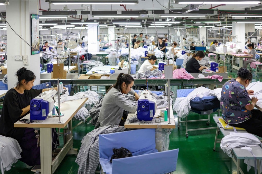 Employees sew clothes for export at a factory in Tongren in southwestern China’s Guizhou province on May 15, 2025. Photo: AFP