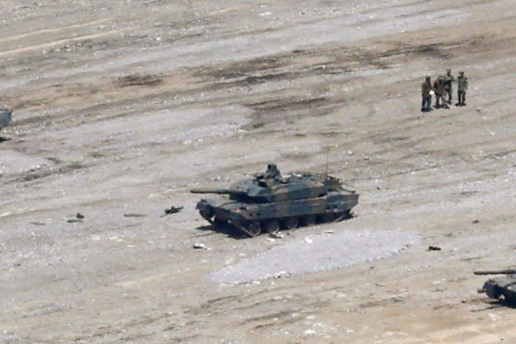 A Japanese Ground Self-Defence Force Type 10 tank (centre) is seen missing its turret after a shell exploded inside on Tuesday. Photo: Kyodo/Reuters