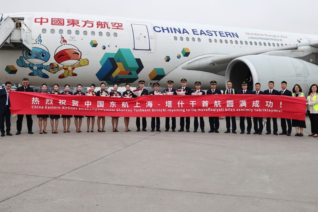 Ground staf and crew members for the inaugural flight of China Eastern Airlines from Shanghai to Tashkent, Uzbekistan, pose for a group photo. A new direct passenger air route connecting the eastern Chinese city of Shanghai and the Uzbek capital of Tashkent was launched in March. Photo: Xinhua