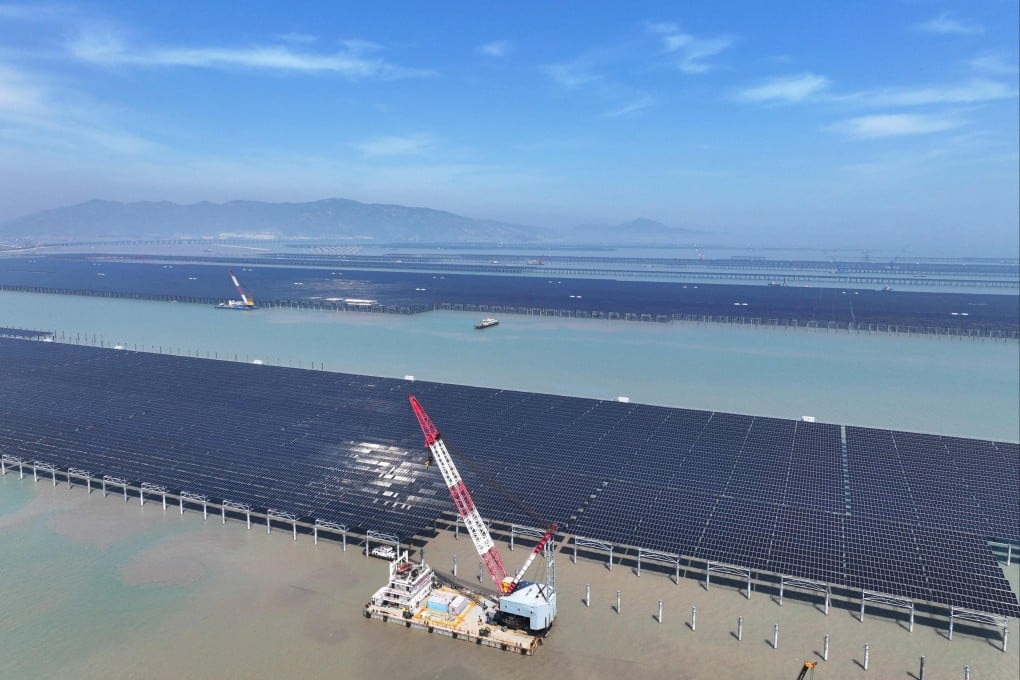 Workers install solar panels with a crane at the site for the CNNC Tianwan project in Lianyungang, in China’s eastern Jiangsu province on April 19. Photo: AFP