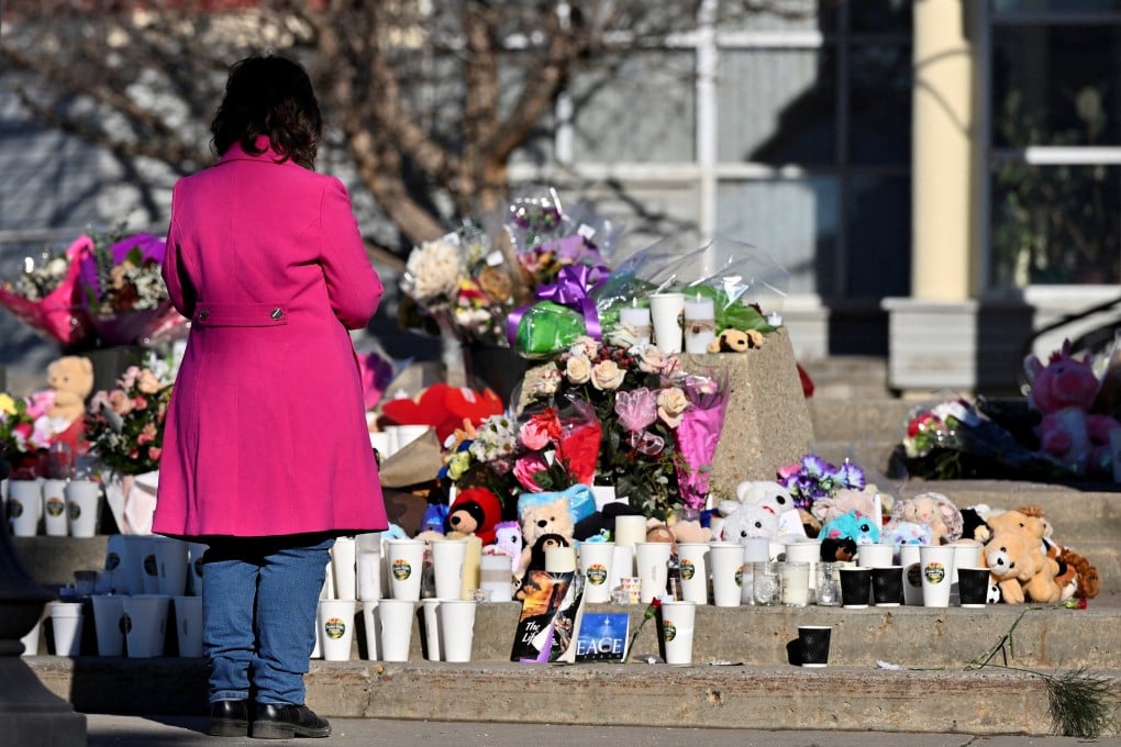 A woman visits a growing makeshift memorial to shooting victims in Tumbler Ridge, British Columbia, Canada, in February. Photo: Reuters