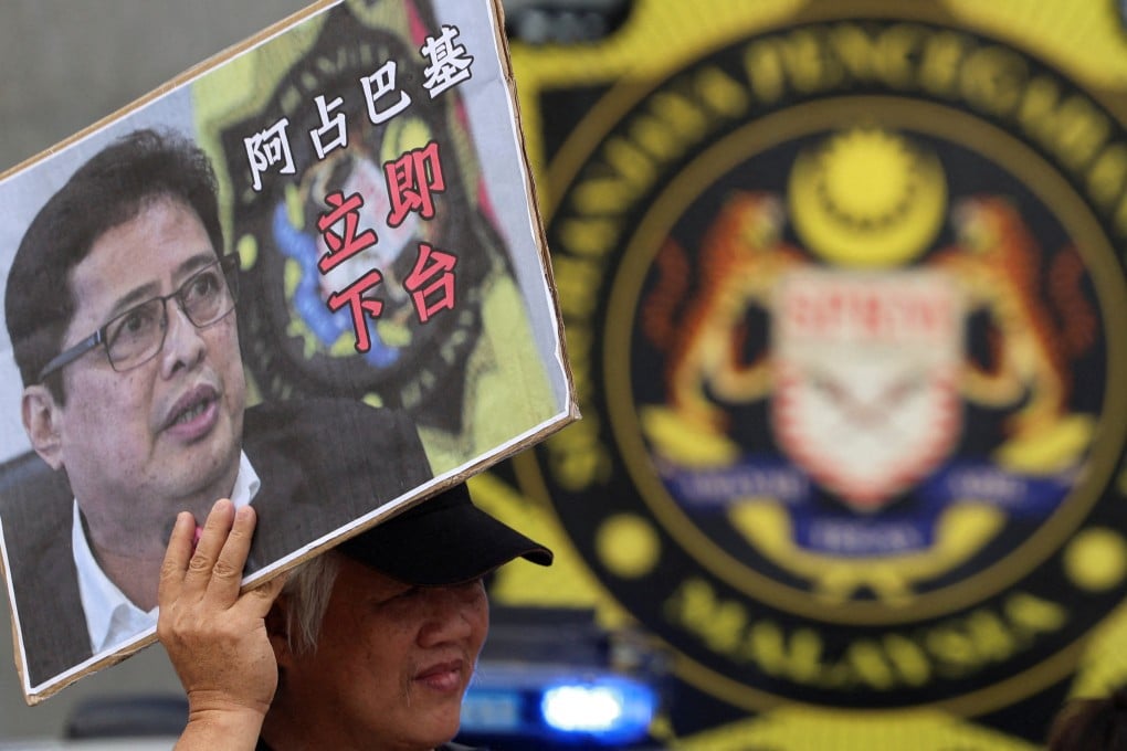 A man holds a placard bearing an image of MACC chief Azam Baki during a protest calling for his resignation outside the agency’s headquarters in Putrajaya, Malaysia, in February. Photo: Reuters