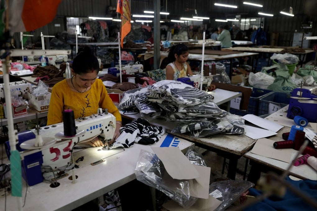 Workers stitch polyester fabric inside the readymade garment manufacturing department of Bindal Silk Mills in Surat, India’s Gujarat state, on April 16. Photo: Reuters