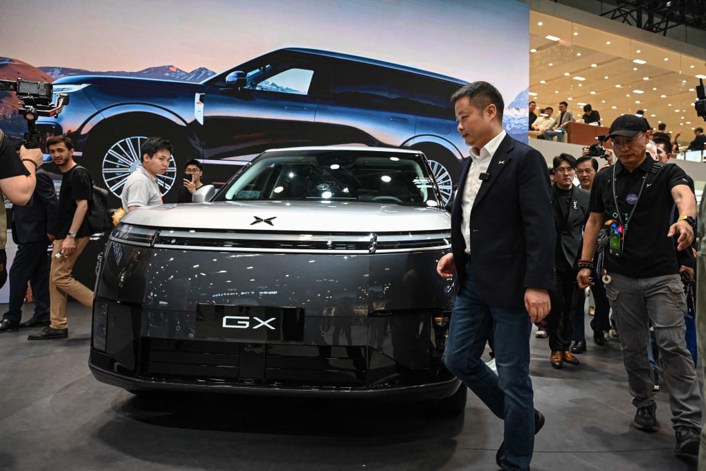 He Xiaopeng, CEO of Chinese electric vehicle maker Xpeng, walks past the new SUV GX six-seater on the opening day of Auto China 2026 in Beijing. Photo: AFP